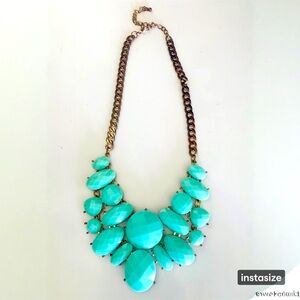 Statement necklace with large turquoise colored stones.